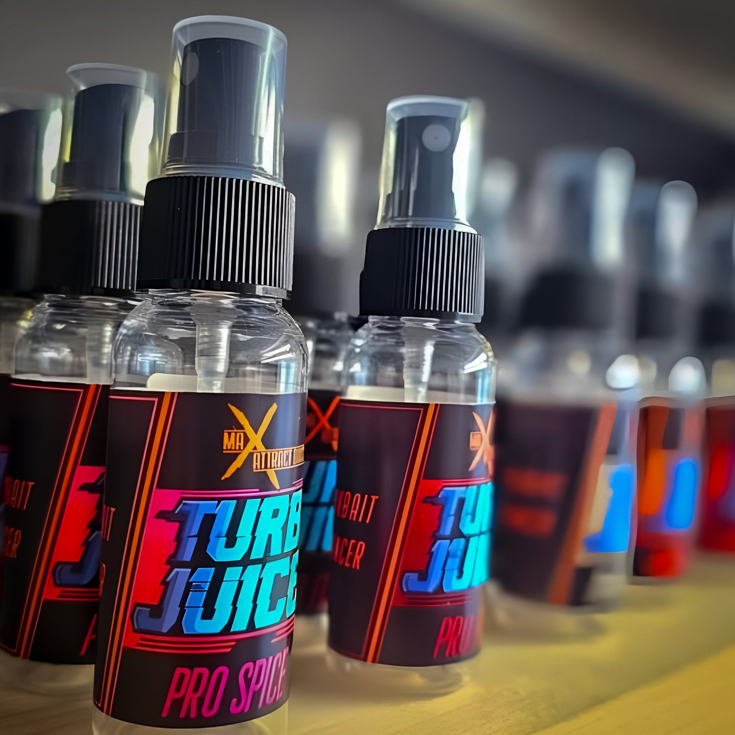 multiple bottle of max attract baits turbo juice neatly lined up on a shelf