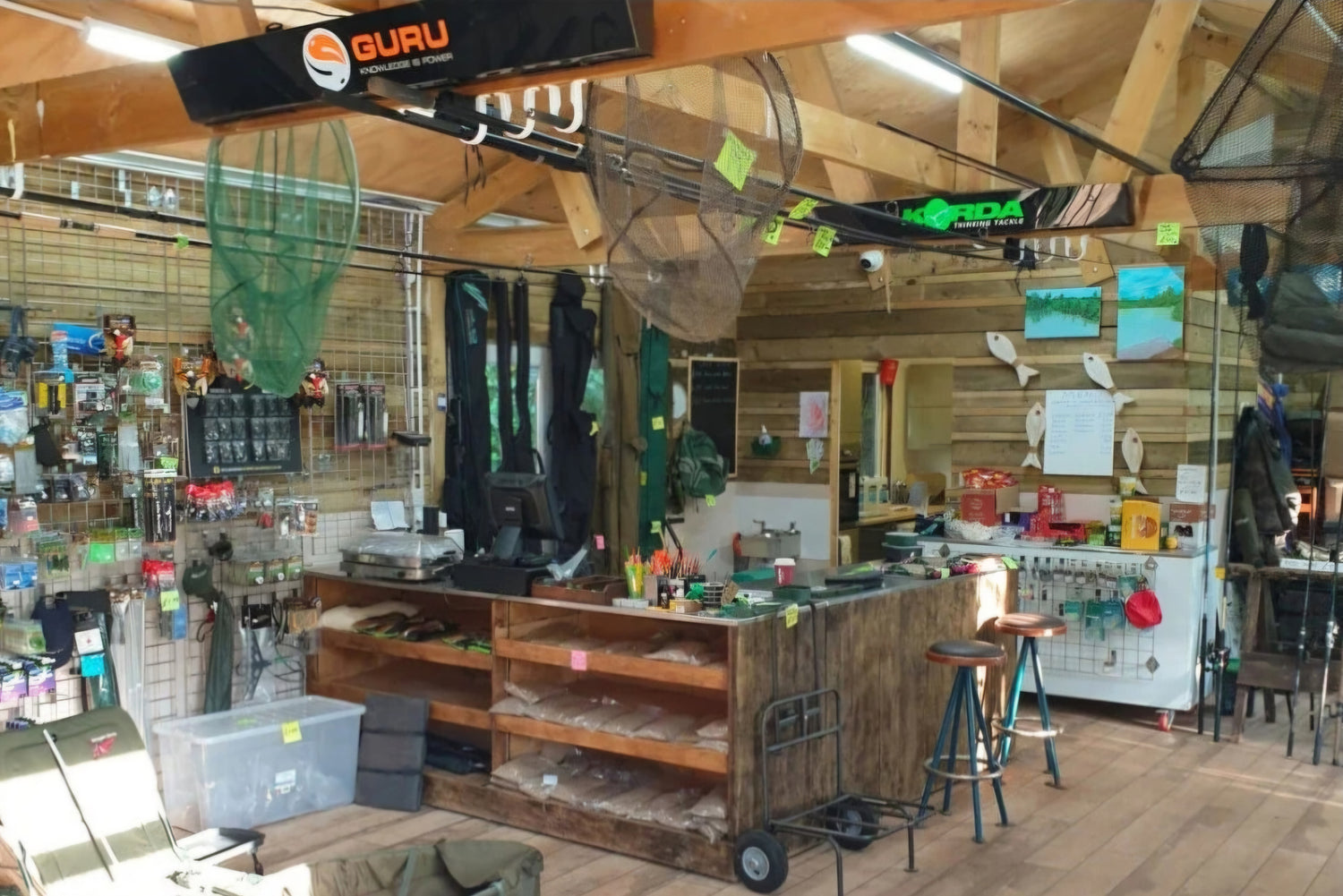 The inside of a small carp tackle shop, with fishing equipment on display