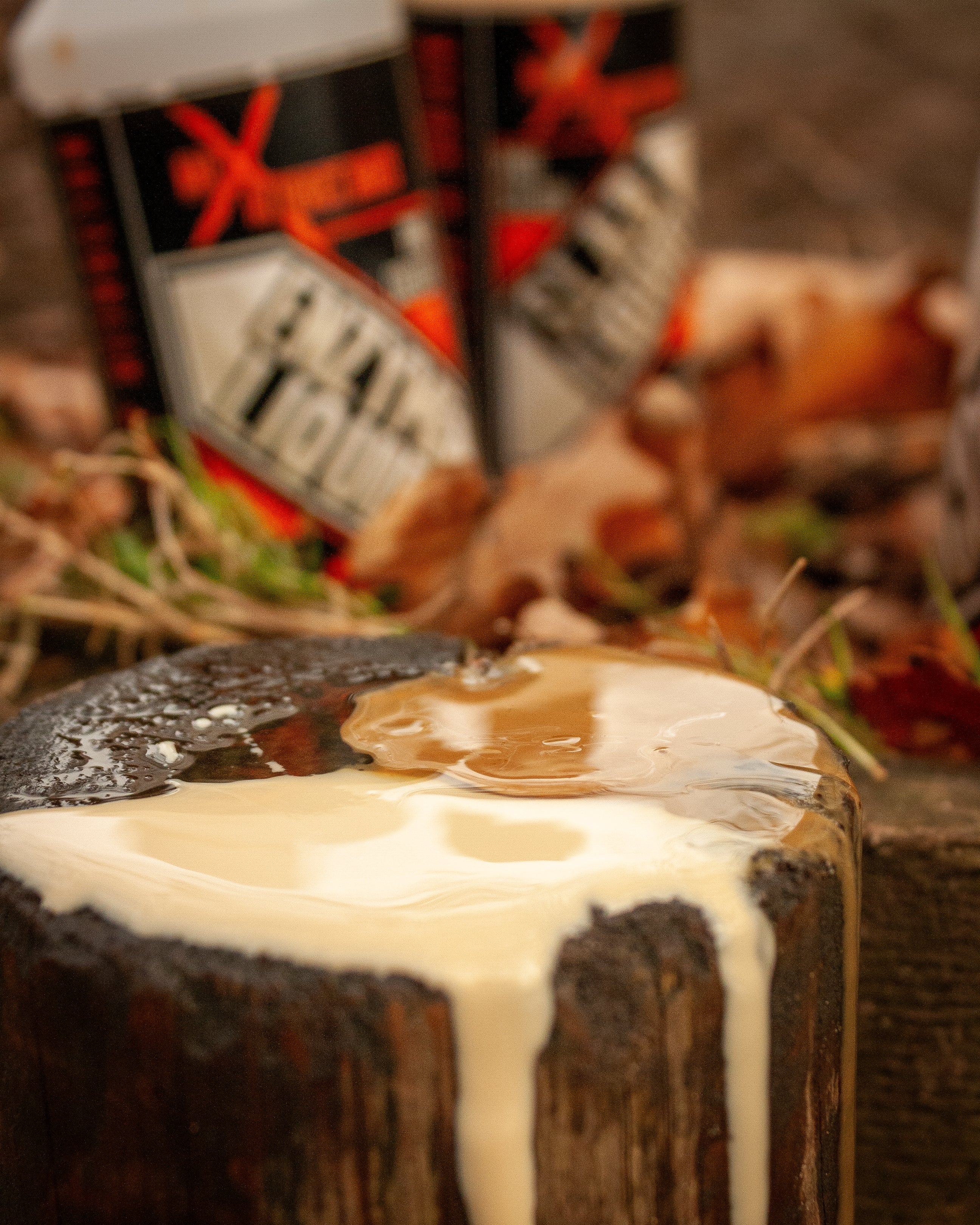 fence post with max attract baits slab liquid on top and dripping down the sump with a bottle of enzyme liquid and slab liquid in the back ground