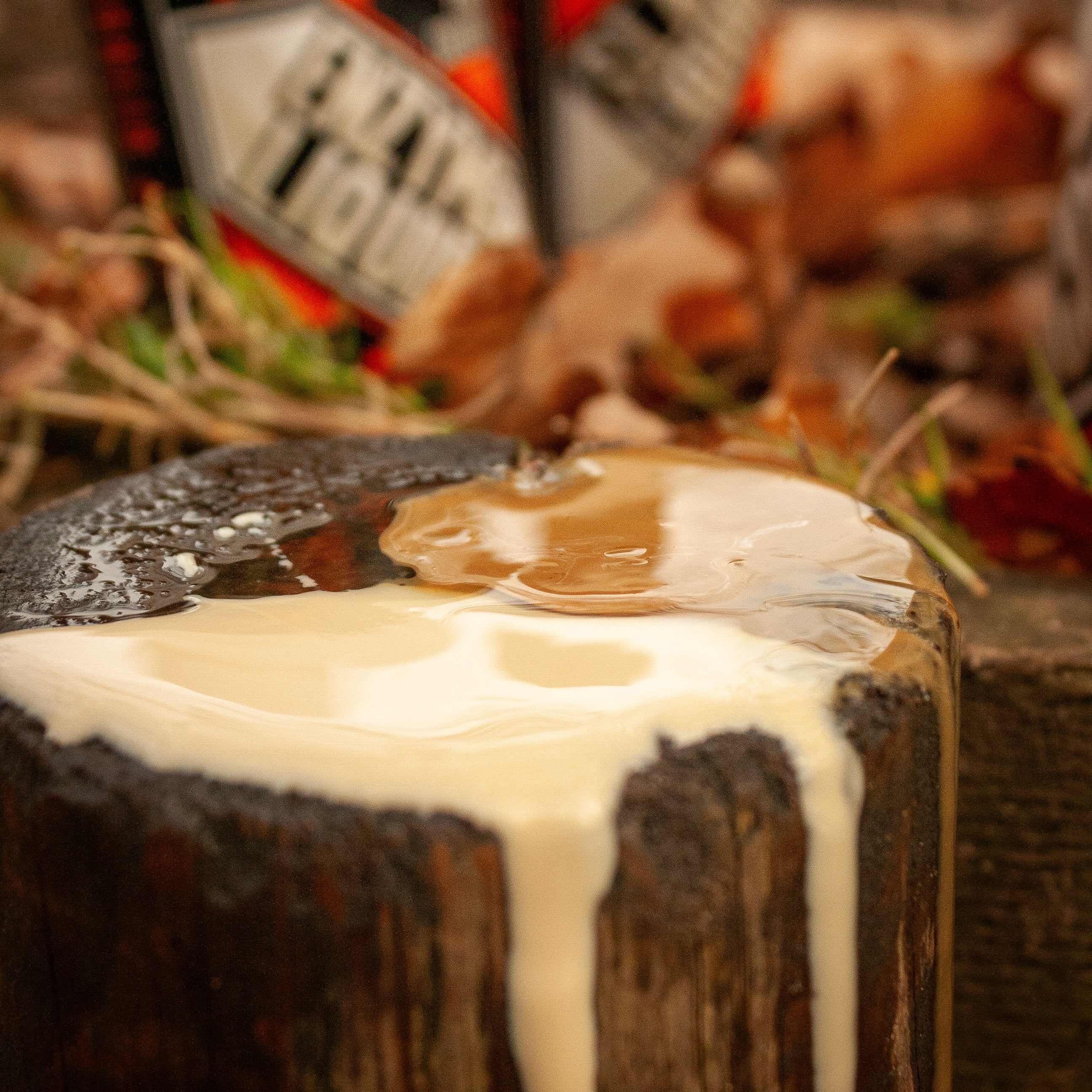 fence post with max attract baits slab liquid on top and dripping down the sump with a bottle of enzyme liquid and slab liquid in the back ground